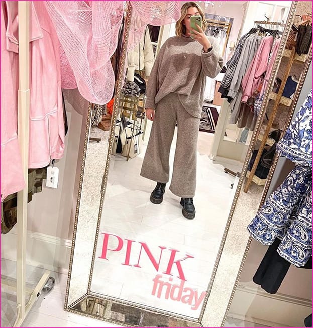 Woman posing in front of a Pink Friday mirror